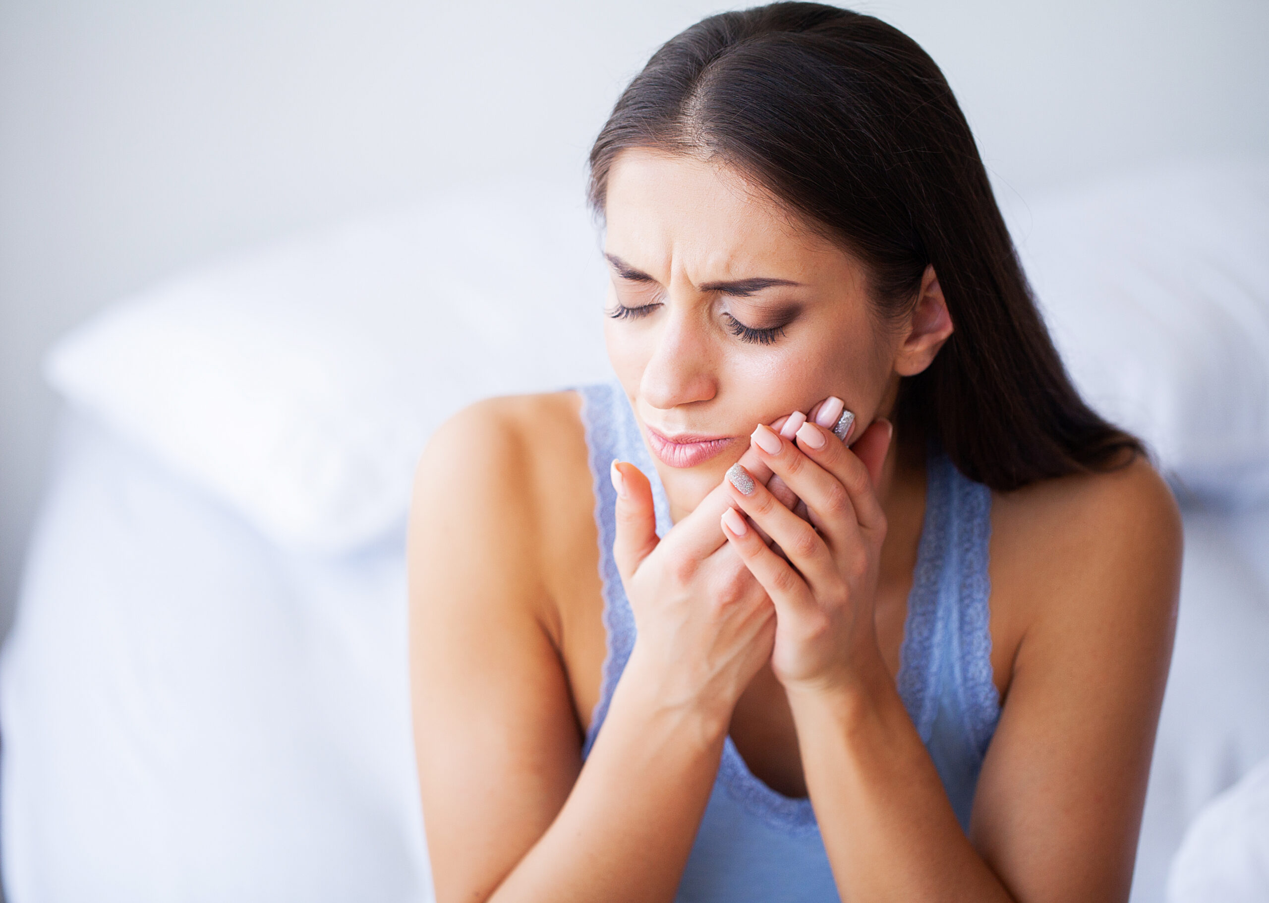 Woman Feeling Tooth Pain and Holding Chin
