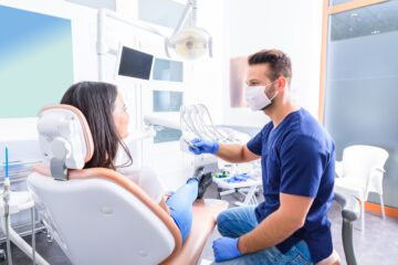 A young Dentist treating a female Patient in a dental practice.