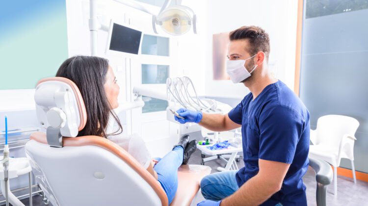 A young Dentist treating a female Patient in a dental practice.