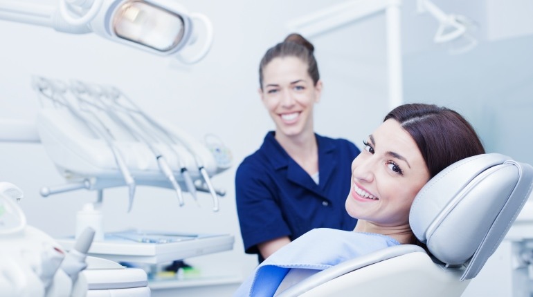 A Woman in a Dental Chair With a Dental Instructor