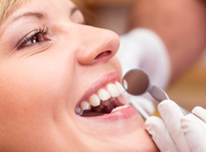 A closeup shot of a ladies face getting her teeths checked