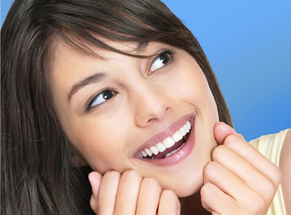 A Woman in Black Hair Smiling With White Teeth